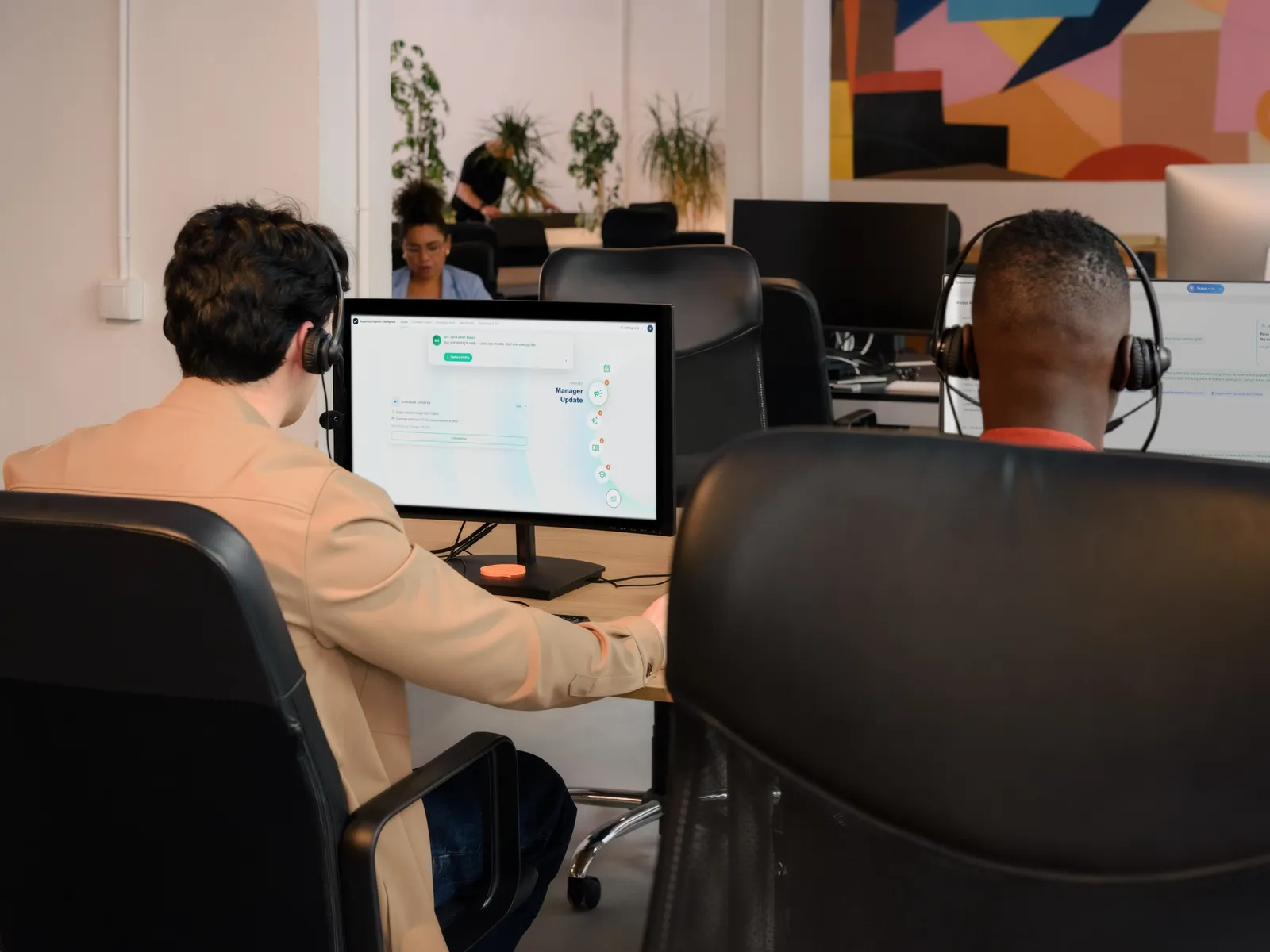 Contact center agents with headsets working at their desks